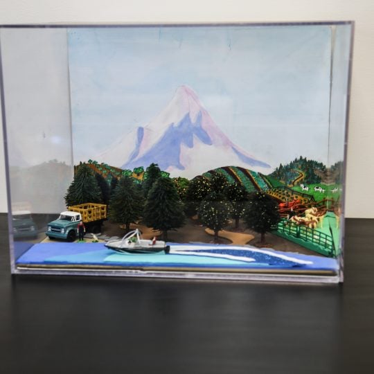 Forced perspective diorama in a clear case that represents some of Oregon's agriculture.