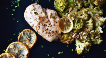 cooked chicken, lemon wedges, and broccoli