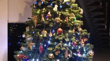 a Christmas tree with decorations and lights on it