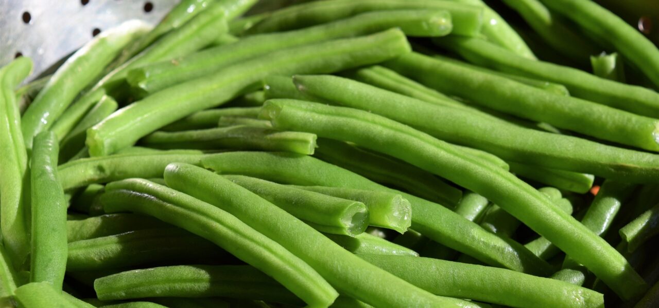close up of green beans in a colander
