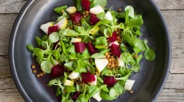 salad with pears in it on a wooden background