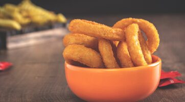 picture of onion rings in an orange bowl