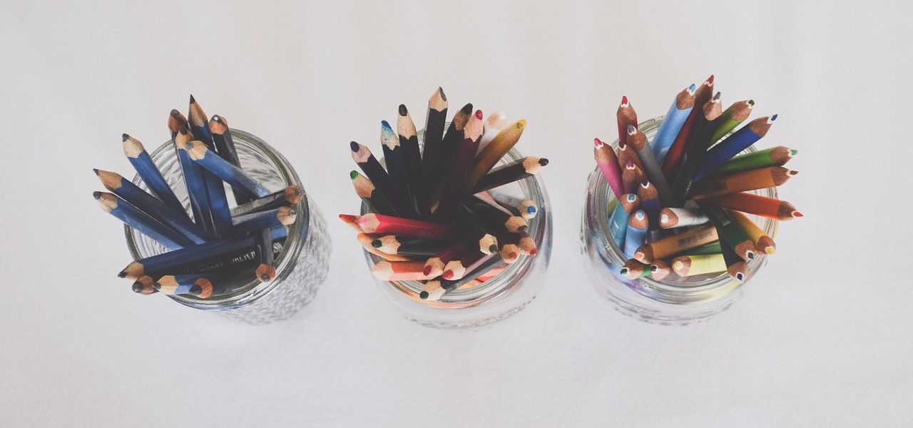 Above view of 3 jars filled with colored pencils