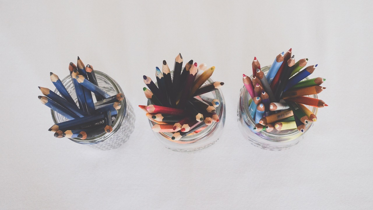 Above view of 3 jars filled with colored pencils