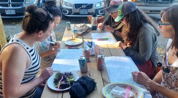 Teachers sit at a table together during a workshop